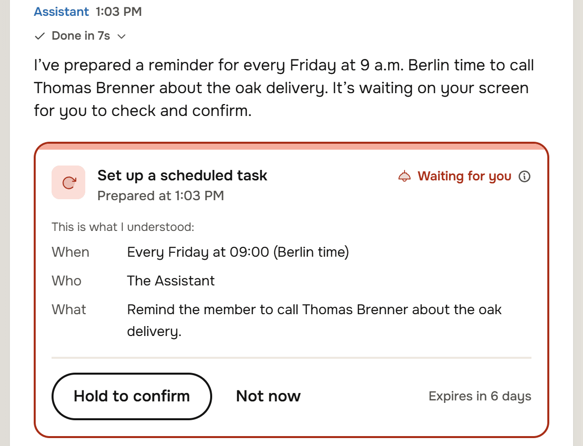 The Assistant's reply: I've prepared a reminder for every Friday at 9 a.m. Berlin time to call Thomas Brenner about the oak delivery. Under it a card, Set up a scheduled task, Waiting for you, with When Every Friday at 09:00 (Berlin time), Who The Assistant, What Remind the member to call Thomas Brenner about the oak delivery, and the buttons Hold to confirm and Not now, Expires in 6 days.